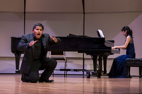 Vocalist and Pianist perform on stage